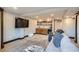Cozy basement living room featuring a wet bar with wooden cabinets and shelving with recessed lighting at 11932 Coal Creek Heights Dr, Golden, CO 80403