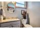 Cozy bathroom featuring a round mirror, granite countertop, and decorative accents at 11932 Coal Creek Heights Dr, Golden, CO 80403