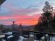 Enjoy the sunset view from the deck of this mountain home at 11932 Coal Creek Heights Dr, Golden, CO 80403