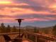 Enjoy the sunset view from the deck of this mountain home at 11932 Coal Creek Heights Dr, Golden, CO 80403