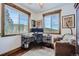 Bright home office with wooden trim windows offering views of the wooded landscape at 11932 Coal Creek Heights Dr, Golden, CO 80403