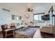 Bright living room featuring hardwood floors, comfortable seating, and a large window with scenic views at 11932 Coal Creek Heights Dr, Golden, CO 80403