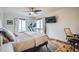 Main bedroom features a ceiling fan, a TV, and windows with nature views at 11932 Coal Creek Heights Dr, Golden, CO 80403