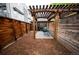 Cozy backyard with wood fence, pergola, and patio seating, perfect for relaxing outdoors at 2714 N Federal Blvd, Denver, CO 80211