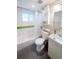 Bathroom featuring a shower-tub combo, sink, and toilet at 2714 N Federal Blvd, Denver, CO 80211