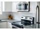 Updated range with a stainless steel Frigidaire microwave in the kitchen at 2714 N Federal Blvd, Denver, CO 80211