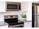Updated stainless steel appliances in the kitchen at 2714 N Federal Blvd, Denver, CO 80211