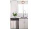 Bright kitchen featuring stainless steel appliances, white cabinetry, and a stylish faucet at 2714 N Federal Blvd, Denver, CO 80211