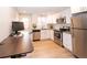 Updated kitchen features stainless steel appliances and sleek, white cabinetry with plenty of natural light at 2714 N Federal Blvd, Denver, CO 80211