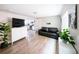 Bright living room featuring wood floors, neutral walls, and views into the adjacent kitchen at 2714 N Federal Blvd, Denver, CO 80211