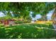 Well-manicured backyard with a lush lawn, privacy fence, and mature trees at 2069 E 116Th Ave, Northglenn, CO 80233