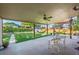 Landscaped backyard with a covered patio, hammock, and well-maintained lawn at 2069 E 116Th Ave, Northglenn, CO 80233