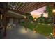 Inviting backyard patio with pergola, outdoor seating, and a lush lawn at sunset at 2069 E 116Th Ave, Northglenn, CO 80233