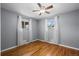 Well-lit bedroom with hardwood floors and neutral walls, lit by natural light from two windows at 2069 E 116Th Ave, Northglenn, CO 80233