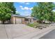 Single-story home with brick facade, attached garage, long driveway, and green front yard at 2069 E 116Th Ave, Northglenn, CO 80233