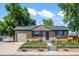 Charming single-story home with brick facade, attached garage, and manicured front yard at 2069 E 116Th Ave, Northglenn, CO 80233