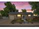 Single-story home at sunset with brick facade, attached garage, and manicured front yard at 2069 E 116Th Ave, Northglenn, CO 80233