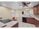 Kitchen featuring tile floors and backsplash, stainless steel sink, dark appliances, and a window at 2069 E 116Th Ave, Northglenn, CO 80233