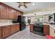 Updated kitchen featuring wood cabinets, stone countertops and backsplash, and new appliances at 2069 E 116Th Ave, Northglenn, CO 80233