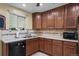 Well-lit kitchen featuring wood cabinets, stainless sink, tile backsplash, and modern appliances at 2069 E 116Th Ave, Northglenn, CO 80233