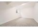 Large empty basement room with neutral carpet and natural light from a small, high window at 16623 E Kent Dr, Aurora, CO 80013