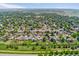 A high angle shows the home's location in a well-maintained neighborhood with mature trees at 11021 Otis St, Westminster, CO 80020