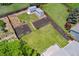 Aerial view of the backyard with well-maintained lawn, wooden privacy fence, raised garden beds, and storage sheds at 11021 Otis St, Westminster, CO 80020