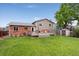 Spacious backyard featuring a lovely deck, a lush lawn and privacy fence, great for outdoor entertaining at 11021 Otis St, Westminster, CO 80020