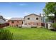 Large backyard features a big lawn, private fence and deck, offering space for leisure and recreation at 11021 Otis St, Westminster, CO 80020