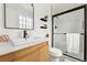 Modern bathroom with sleek vanity, black fixtures, and a glass-enclosed shower at 11021 Otis St, Westminster, CO 80020