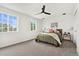 Cozy bedroom with plush carpet, white walls, and bright natural light from two large windows at 11021 Otis St, Westminster, CO 80020