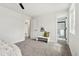 Well-lit bedroom with plush carpet, a seating bench, and an ensuite bathroom at 11021 Otis St, Westminster, CO 80020