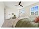 Bright bedroom with large windows, soft carpet, and a comfortable bench for relaxation at 11021 Otis St, Westminster, CO 80020