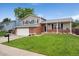 Charming two-story home with a well-manicured front yard and a two-car garage in a suburban setting at 11021 Otis St, Westminster, CO 80020