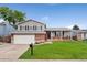 Charming two-story home with a well-manicured front yard and a two-car garage in a suburban setting at 11021 Otis St, Westminster, CO 80020