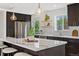 Bright and open kitchen with large marble island, stainless appliances, and eat in nook at 11021 Otis St, Westminster, CO 80020