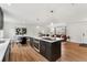 Open concept kitchen with large island, stainless appliances, and open view to the living room at 11021 Otis St, Westminster, CO 80020