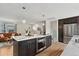 Contemporary kitchen with island, stainless steel appliances and open view to the living room at 11021 Otis St, Westminster, CO 80020