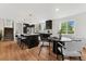 Modern kitchen featuring dark cabinets, a large island with marble countertops, and stainless steel appliances at 11021 Otis St, Westminster, CO 80020