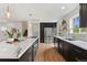Well-lit kitchen featuring stainless steel appliances, marble countertops and dark wood cabinets at 11021 Otis St, Westminster, CO 80020