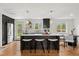 Modern kitchen with stainless steel appliances, a large island with seating, and stylish pendant lighting at 11021 Otis St, Westminster, CO 80020