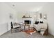 Cozy living room with fireplace, white furniture, and lots of natural light at 11021 Otis St, Westminster, CO 80020