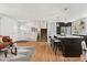 Open-concept living area featuring a kitchen island with seating, hardwood floors, and bright, natural light at 11021 Otis St, Westminster, CO 80020