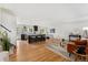 Open-concept living area featuring a kitchen island with seating, hardwood floors, and bright, natural light at 11021 Otis St, Westminster, CO 80020