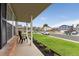 Inviting front porch with seating, complemented by a brick facade and landscaped garden beds at 11021 Otis St, Westminster, CO 80020