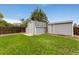 Backyard storage sheds nestled on the lawn with a wooden privacy fence creating secluded space at 11021 Otis St, Westminster, CO 80020