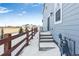 Steps leading to backyard with wooden fence and snowy ground at 2060 Chambers Rd, Brighton, CO 80601