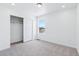 Well-lit bedroom with carpet, closet, and window offering natural light at 2060 Chambers Rd, Brighton, CO 80601