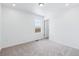 Spacious bedroom with neutral wall and carpet and window at 2060 Chambers Rd, Brighton, CO 80601