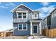 Two-story house with gray siding, a dark gray door, and a small front yard at 2060 Chambers Rd, Brighton, CO 80601